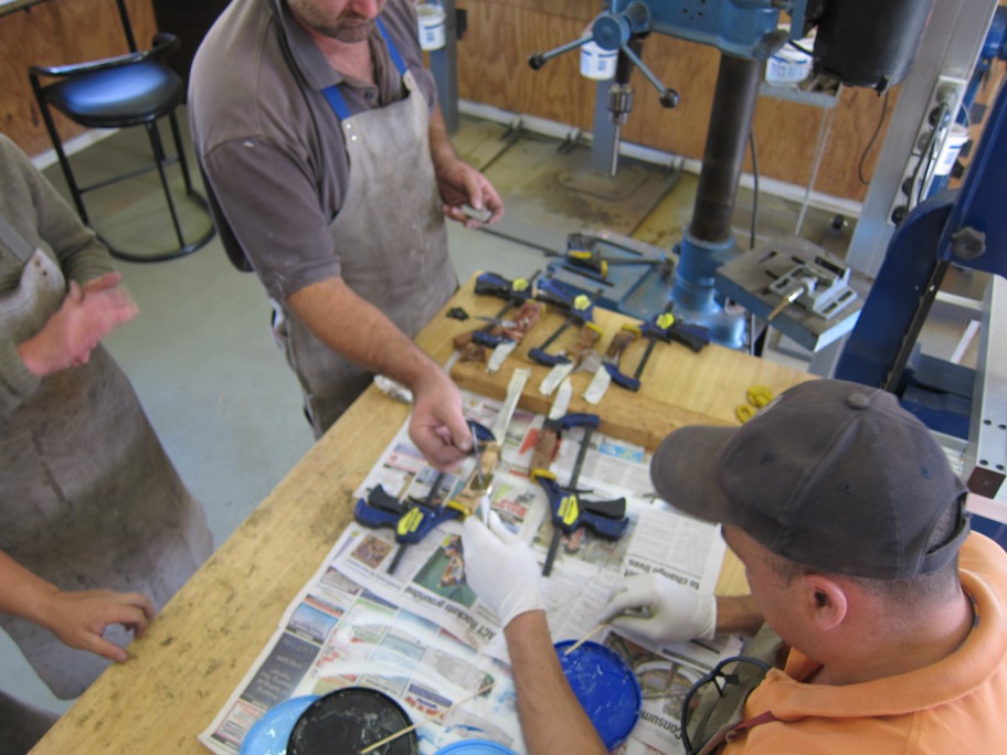 Adrian watching his handle get glued together with epoxy resin.