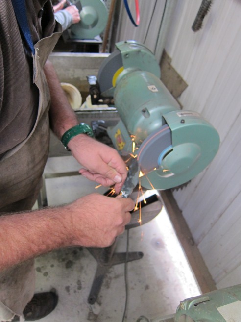 Adrian grinding the knife shape.
